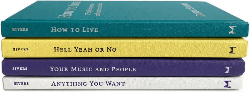 stack of four hardcover books by Derek Sivers